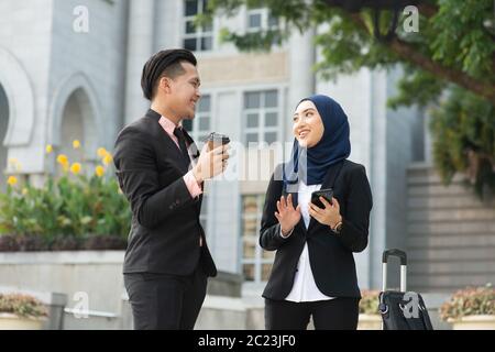 Young entrepreneurs talking outdoor, business travelling. Stock Photo