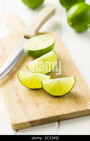 The green sliced lime on cutting board. Stock Photo