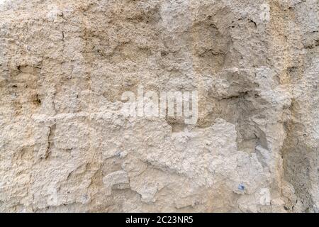 Sand wall of light sand with small pebbles as background Stock Photo