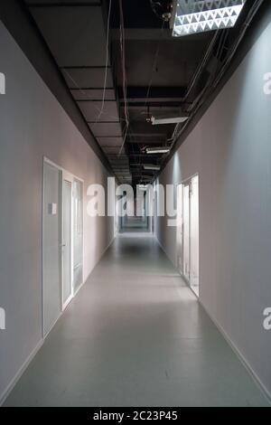 Long narrow corridor with doors in the office or workplace Stock Photo