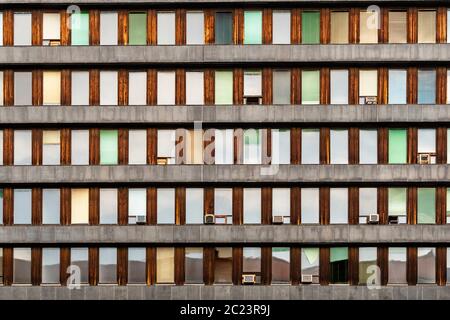 Evening reflections on small aligned windows. Architecture details.