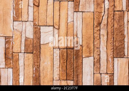 Rock stone brick tile wall has a detailed background texture sepia cream brown color stacked in layers, you can use this image a Stock Photo