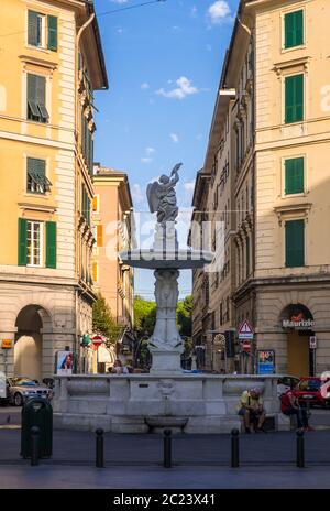 Genoa, Italy - August 20, 2019: The fountain of the Genio Marino, made of white marble in Piazza Colombo Square in Genoa, Liguria region Stock Photo