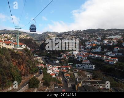 aerial cityscape view of the city of funchal from the cable car running up the mountain to monte Stock Photo