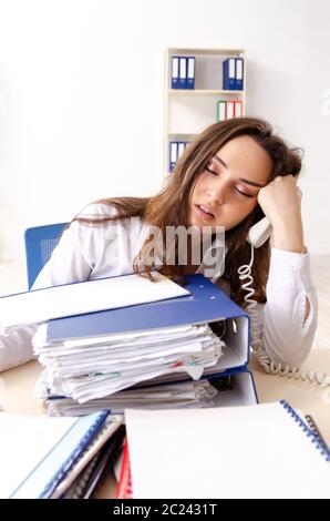 Young female employee unhappy with excessive work Stock Photo