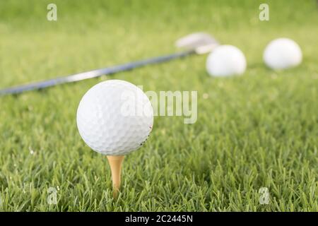 Golf ball sitting on tee putting in golf course. Golf ball on tee ready to be shot Stock Photo