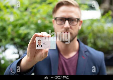 Bailiff standing at house entrance showing id Stock Photo - Alamy