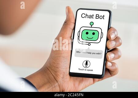 Close-up Of Woman Using Chat Bot Application For Chatting On Smartphone Stock Photo
