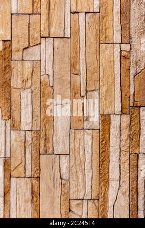 Rock stone brick tile wall has a detailed background texture sepia cream brown color stacked in layers, you can use this image a Stock Photo