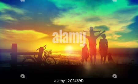 Family with children watching a bright and fabulous sunset. Stock Photo