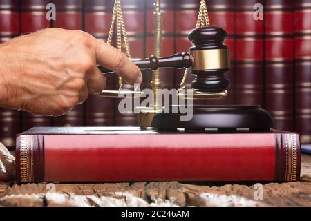 Male Judge In A Courtroom Striking The Gavel Stock Photo
