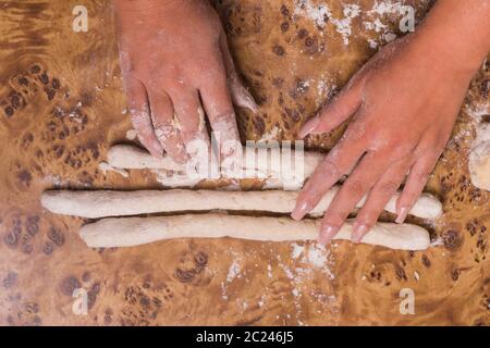 two hands making pasta. hands preparing gnocchi Stock Photo