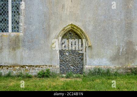 St Nicholas' Church, Oakley, Suffolk, with a door blocked and bricked up with a flint wall. Stock Photo