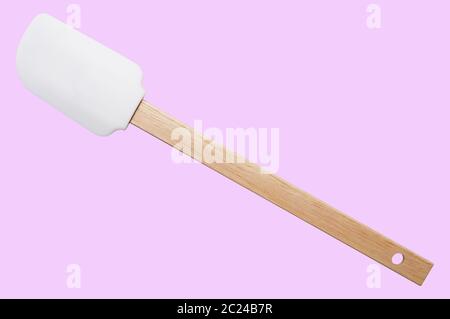 Kitchen spatula silicone with wooden handle on pink background. Isolated Stock Photo