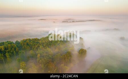 Summer nature landscape aerial panorama. Morning fog over river, meadow and forest. Amazing nature sunlight scene at foggy sunrise. Belarus, Europe Stock Photo