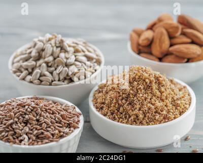 Homemade LSA mix in plate and Linseed or flax seeds, Sunflower seeds and Almonds. Traditional Australian blend of ground, source of dietary fiber, pro Stock Photo