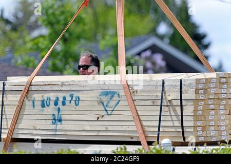 2X4 lumber being delivered to a residential house construction site Stock Photo