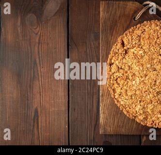 pieces of crumble pie with apples on a brown wooden board, copy space Stock Photo