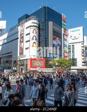 Mass crowd walking across the famous Shibuya pedestrian scramble crossing, Tokyo, Japan. Stock Photo