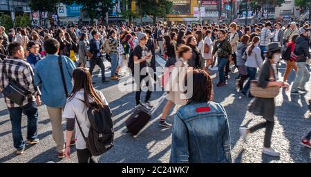 Mass crowd walking across the famous Shibuya pedestrian scramble crossing, Tokyo, Japan. Stock Photo