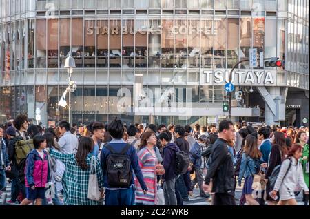 Mass crowd walking across the famous Shibuya pedestrian scramble crossing, Tokyo, Japan. Stock Photo