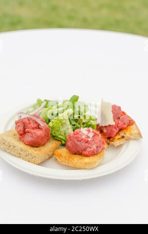 VARIATIONS tartare mature ABERDEEN ANGUS BEEF STEAK / RUSTIKAL - seasoned only Maldon salt and fresh pepper, served on wheat toast with extra virgin o Stock Photo
