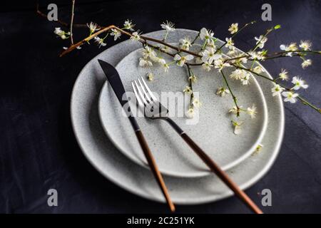 Spring table setting with blooming tree branch Stock Photo