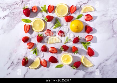 Concept collage for cold pink strawberry flavoured jin and tonic garnished with fresh fruits and mint leaves. Stock Photo