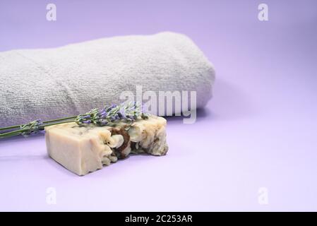 A soap bar and lavender and towel on the grey background. Stock Photo