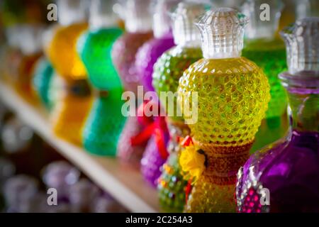 Gift cologne bottles in different colors with selective focus. Stock Photo