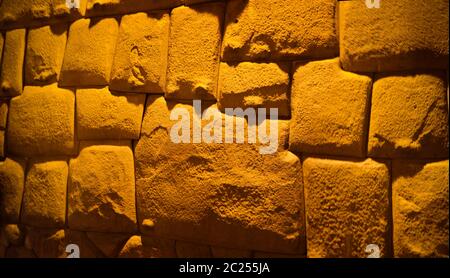 View to Twelve-angled stone aka Hatun Rumiyoc as a part of a wall of the palace of the Archbishop of Cuzco, Peru Stock Photo