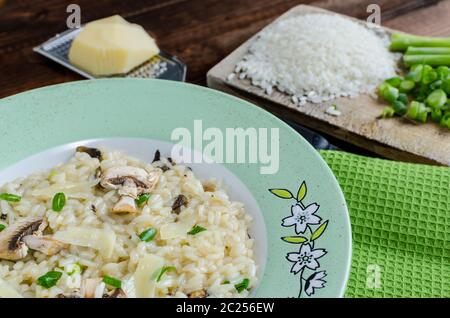 Italien risotto with mushrooms and spring onion Stock Photo