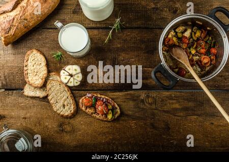 Bruschetta with Mediterranean vegetables fried in olive oil, garlic and fresh herbs Stock Photo