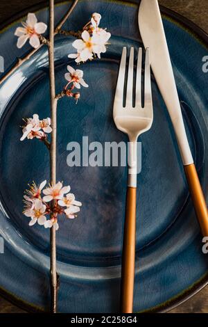 Spring table setting with blooming tree branch Stock Photo