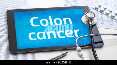 The word Colon cancer on the display of a tablet Stock Photo
