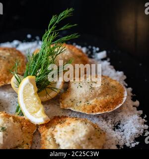 deep fried Hokkaido Scallops Shell with crusty bread serve with lemon and salt designed for square crop using. Stock Photo