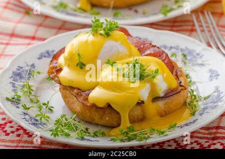 Eggs benedict, prosciutto topped with Hollandaise sauce Stock Photo