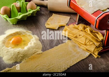 Homemade spaghetti carbonara with semolina - production, pasta machine Stock Photo