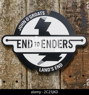 Land's End to John O'Groats sign on wooden background. The nothermost part of mainland in Scotland.