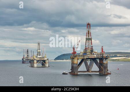 Large offshore oil rig drilling platforms off the coastline near Invergordon in Scotland. Stock Photo