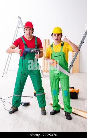 Two workers contractors working indoors Stock Photo