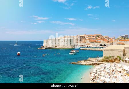 Amazing panoramic view of the old port of Dubrovnik with medieval fortifications on Adriatic Sea and Banje beach, Croatia, Europe. Stock Photo