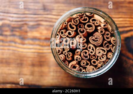 Cinnamon Sticks in Jar on Wooden Table. View from Above and Copy Space. Stock Photo