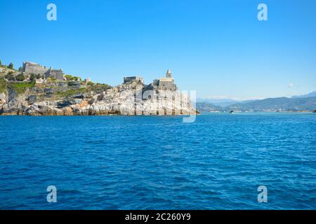 The gothic Church of St Peter and Doria Castle on the rocky peninsula at the entrance to the gulf of Poets at Porto Venere Italy on the Ligurian Coast Stock Photo