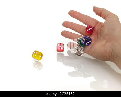 Woman throwing some colorful dices with her hands isolated on white background. Gambling Stock Photo