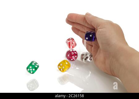 Woman throwing some colorful dices with her hands isolated on white background. Gambling Stock Photo