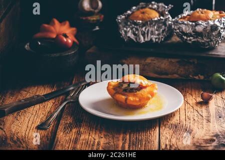 Baked Pattypan squash stuffed with ground meat on white plate Stock Photo