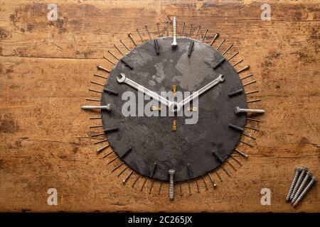 A watch made from screws, nails and two wrench keys Stock Photo