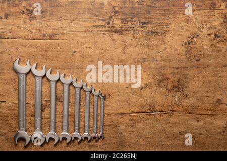 A set of wrench keys on a vintage wooden background Stock Photo