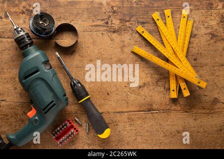 Overhead view of a workbench with hand tools and a drill Stock Photo